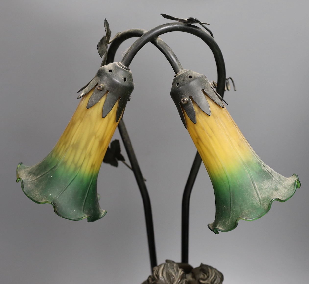 Two bronzed metal figural table lamps, with Art Nouveau style glass shades, 66cm total